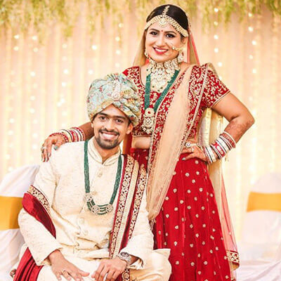 Beautiful Indian couple holding hands in traditional attire